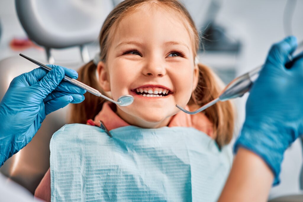 A joyful child laughing during a visit to a children's dentistry clinic in Calhoun, showcasing a comfortable and friendly dental experience.